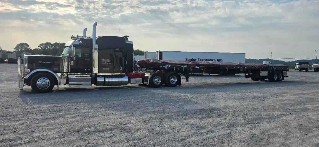 Black flatbed truck in motion